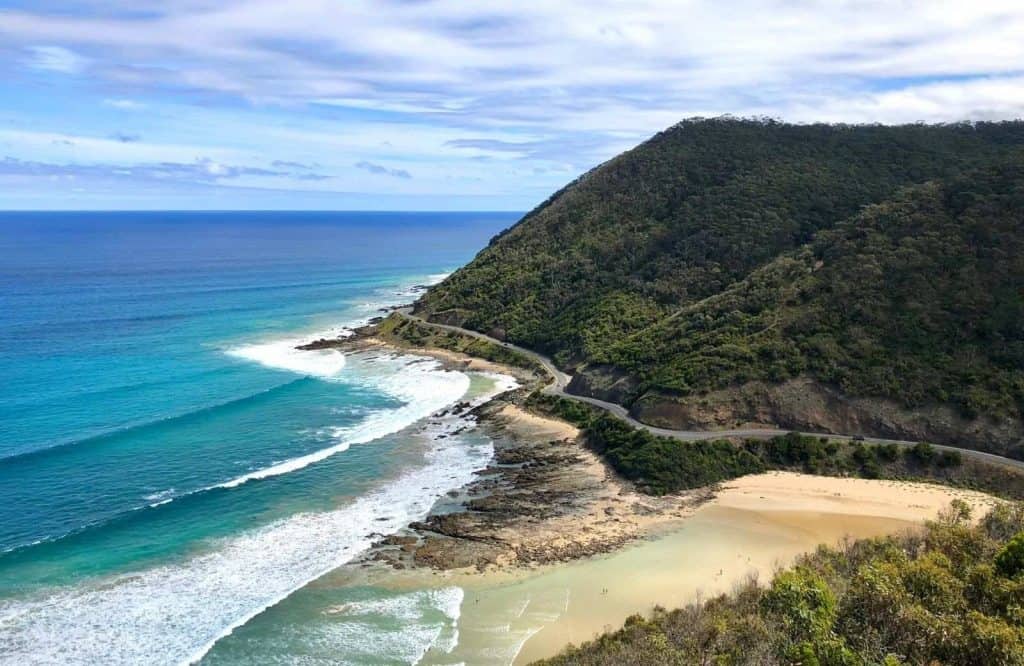 A road on a cliffside on the ocean which is the town of Lorne and is one of the most gorgeous Great Ocean Road stops.