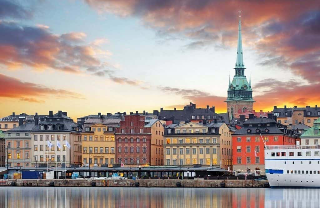 Colorful clouds in the background and city line of Stockholm on the water