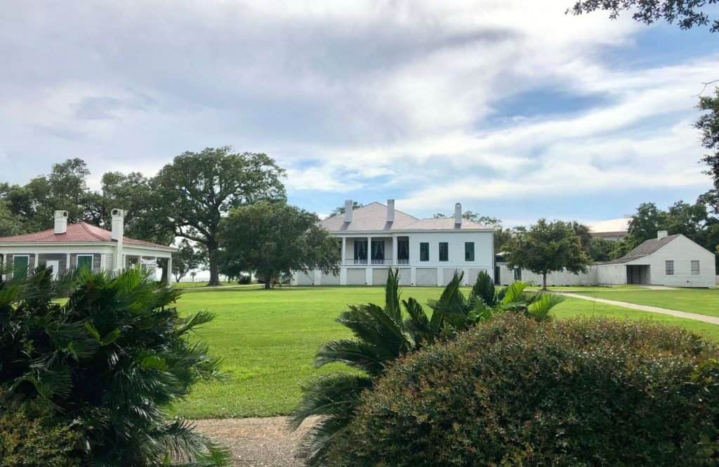 Three white houses set on a manicured lawn known as Beauvoir and is one of the best things to do in Biloxi Mississippi.