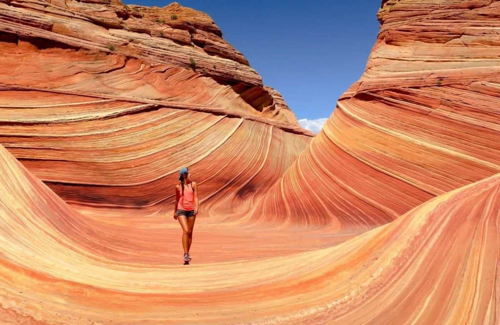 A woman standing on a striped canyon for traveling alone quotes.