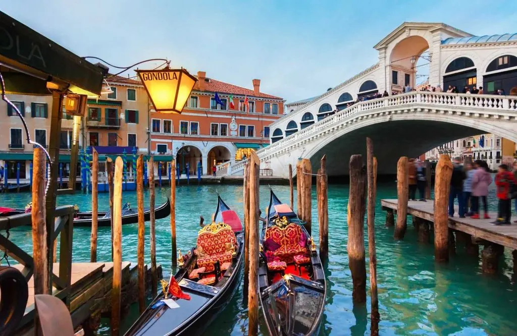 Gondolas on the canal in Venice, and going on a gondola ride is one of the best things to know before visiting Venice.