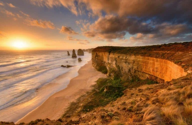 Cliffs along the beach at sunset or sunrise for the best Great Ocean Road stops.
