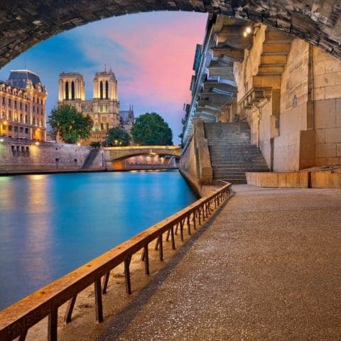 The Seine River in the evening time with pink and blue skies for Paris quotes.