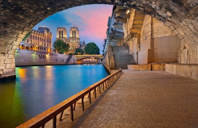 The Seine River in the evening time with pink and blue skies for Paris quotes.