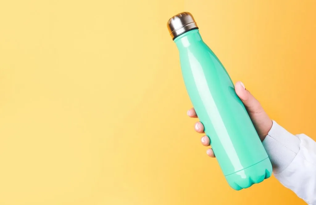 A turquoise reusable water bottle which is on your Tulum packing list. 
