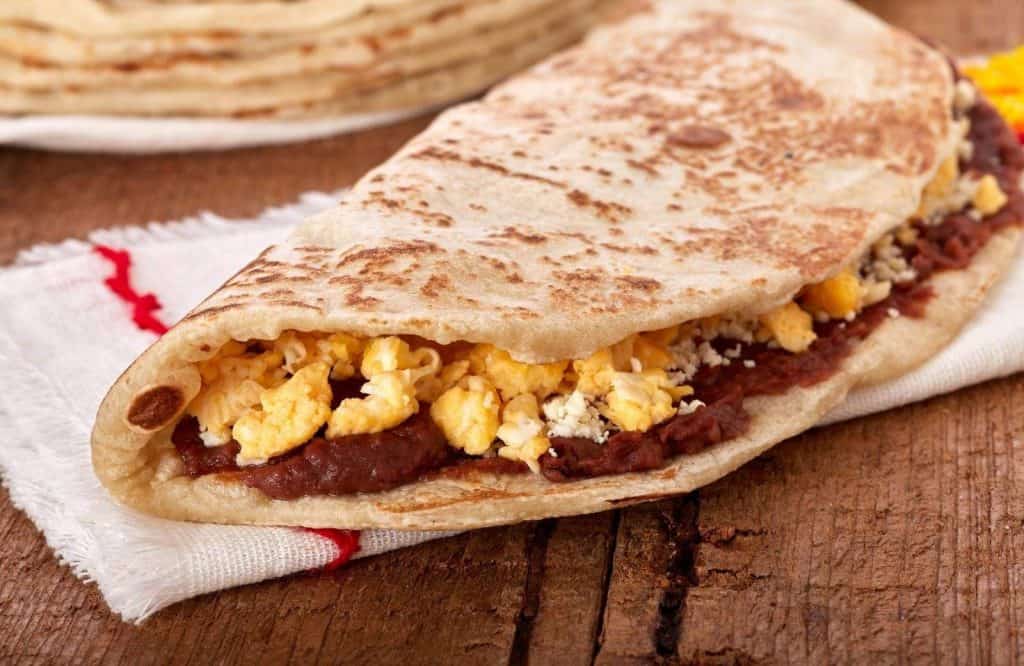 Tortilla filled with eggs and beans, known as baleada, which is a must eat during your one day in Roatan trip.