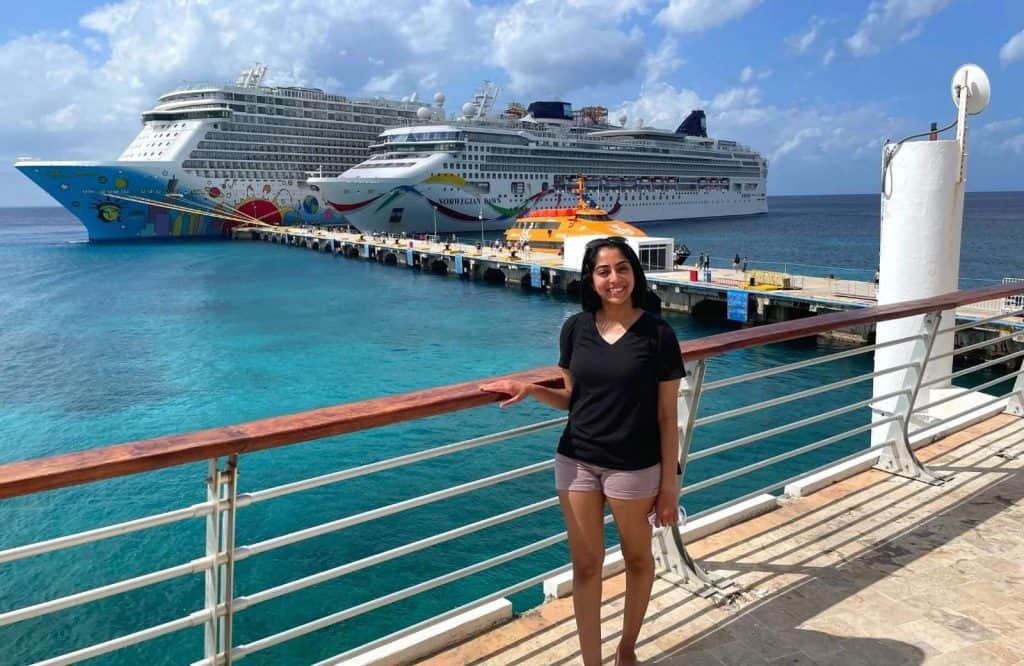 Me standing in front of two cruise ships and saying yes to the question "Is Cozumel safe?"
