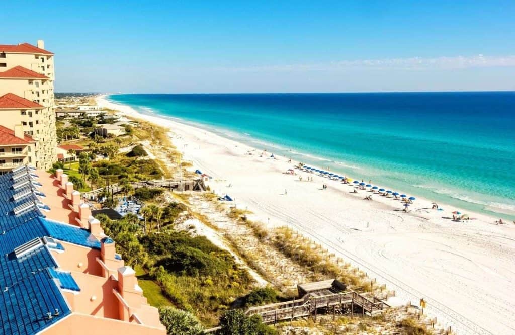 Condos on the beach with white sand and turquoise waters of Destin, which is one of the best beaches in the Florida Panhandle. 