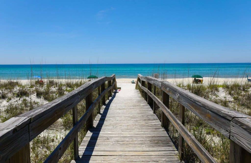 A wooden pathway leading down to Henderson Beach State Park, which is one of the best beaches in the Panhandle of Florida.