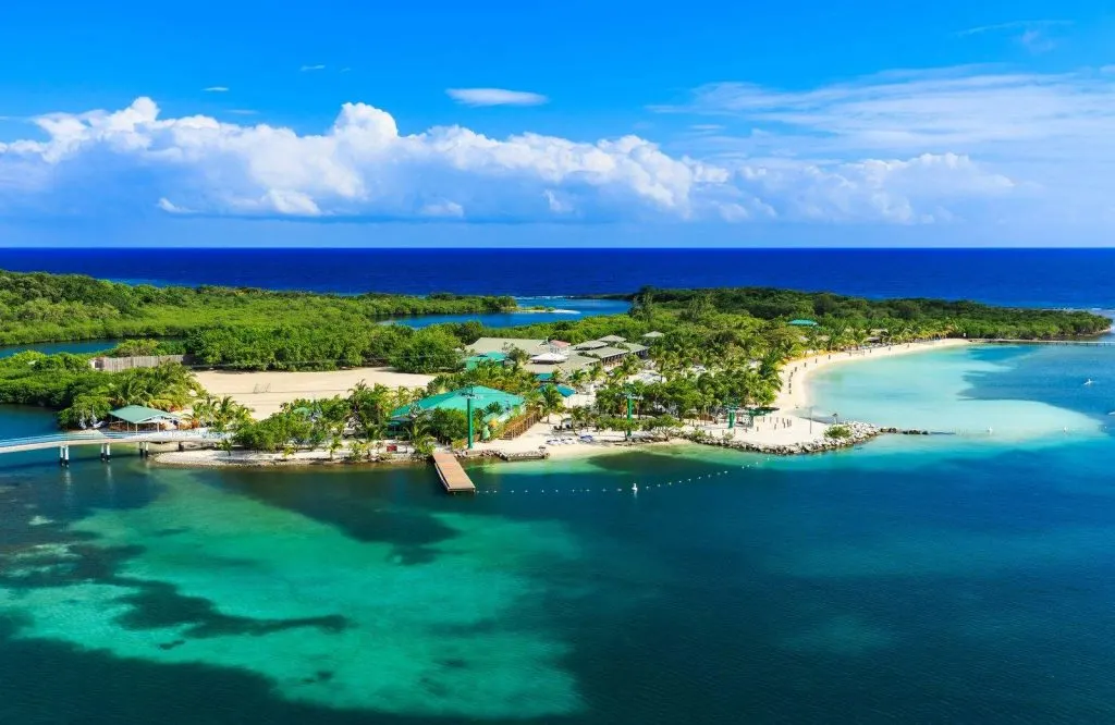 An aerial view of the island with its emerald and blue waters with a panoramic view of the island for the best one day in Roatan.