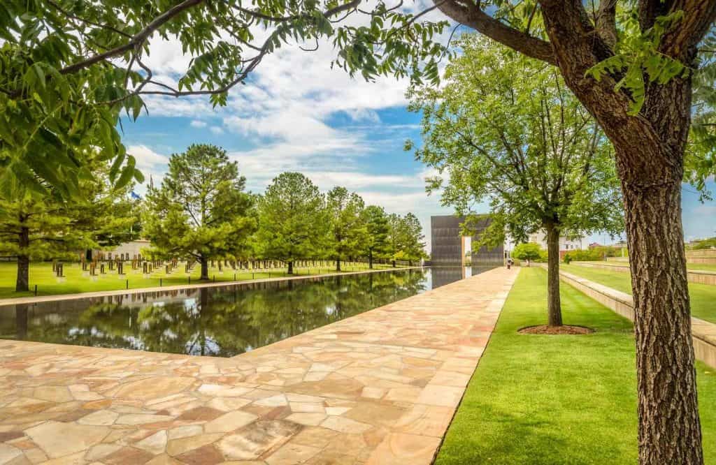 A beautiful manicured lawn with a reflecting pool, which is the Oklahoma City National Memorial and Museum, which is a must visit during a one day in Oklahoma City trp.