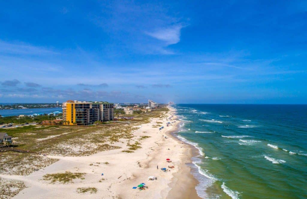 Aerial view of the sandy shore and green blue waters of Perdido Key which is one of the most beautiful beaches Panhandle Florida.