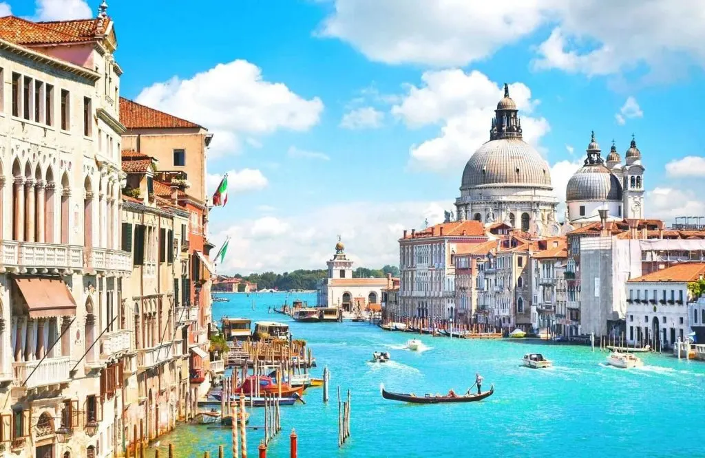 The beautiful blue canals of Venice, which is showing what is Italy known for.