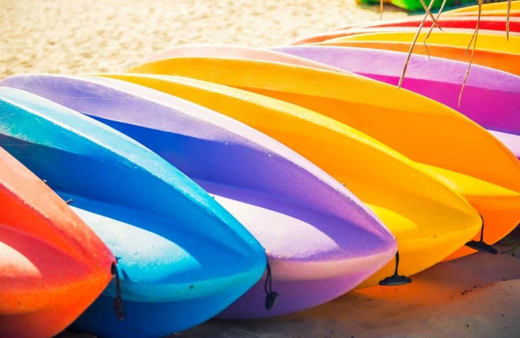Colorful kayaks on the sand.