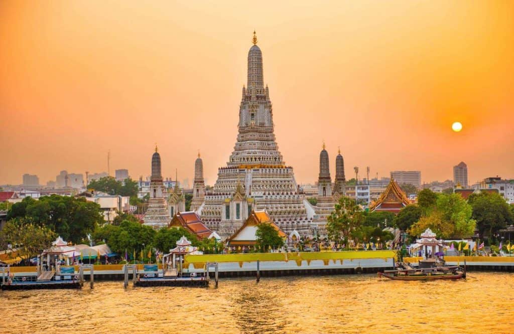 A temple at sunset in Bangkok, which is one of the best places in Thailand.