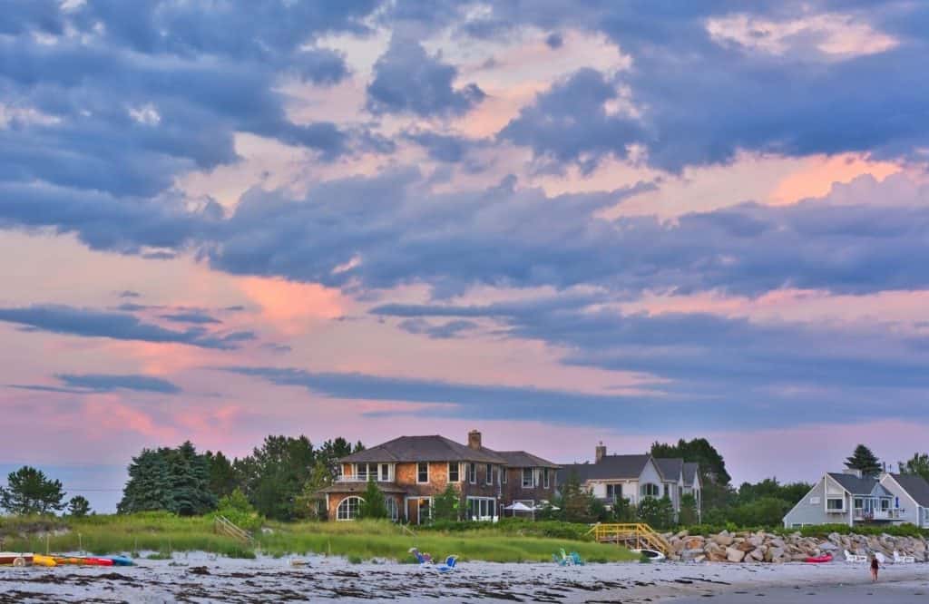 Houses on the shoreline with cotton candy skies, which is one of many things to do in Kennebunkport.