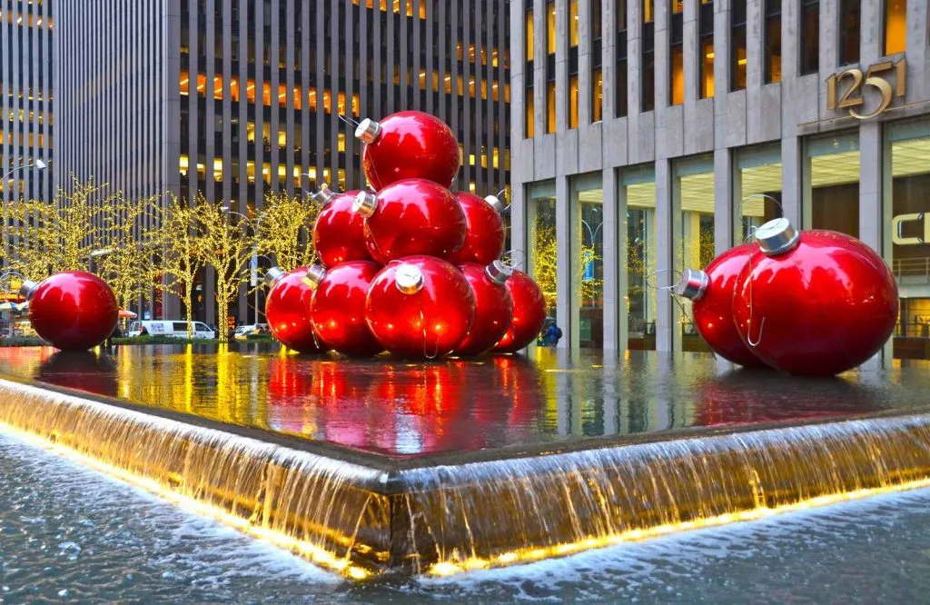 Giant red Christmas ornaments on Sixth Avenue in New York City.