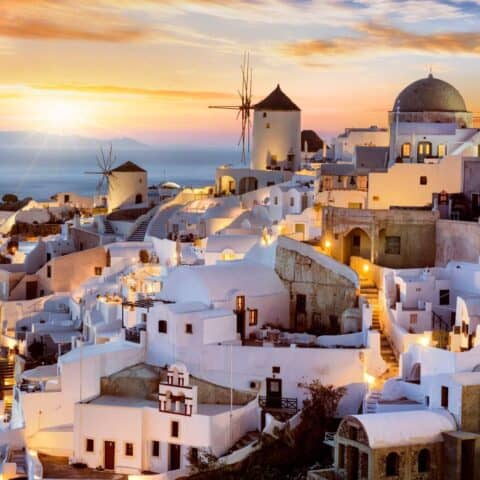 White-washed buildings at sunset on one of the best Greek islands for couples.