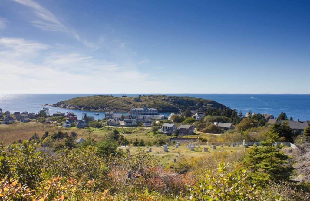 Aerial view of Monhegan Island with lush greenery and blue skies.