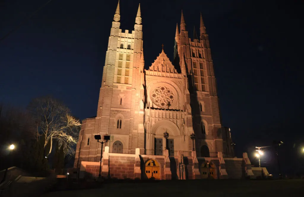 The Basilica of Saints Peter and Paul in Lewiston, Maine lit up at night.