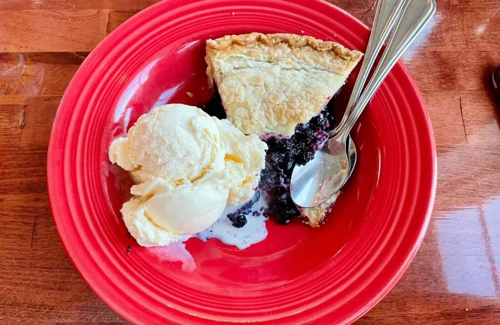 Red plate with blueberry pie and ice cream at Alisson's Restaurant in Kennebunkport, Maine.