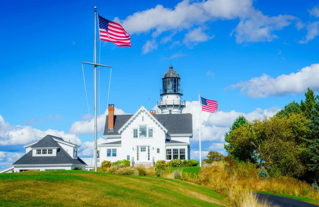 Cape Elizabeth Light near Casco Bay with two American flags.