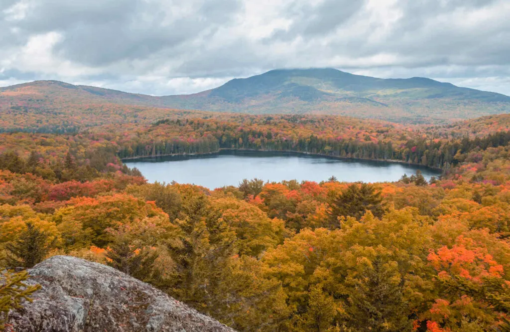 Aerial view of Moosehead Lake with fall foliage surrounding it.