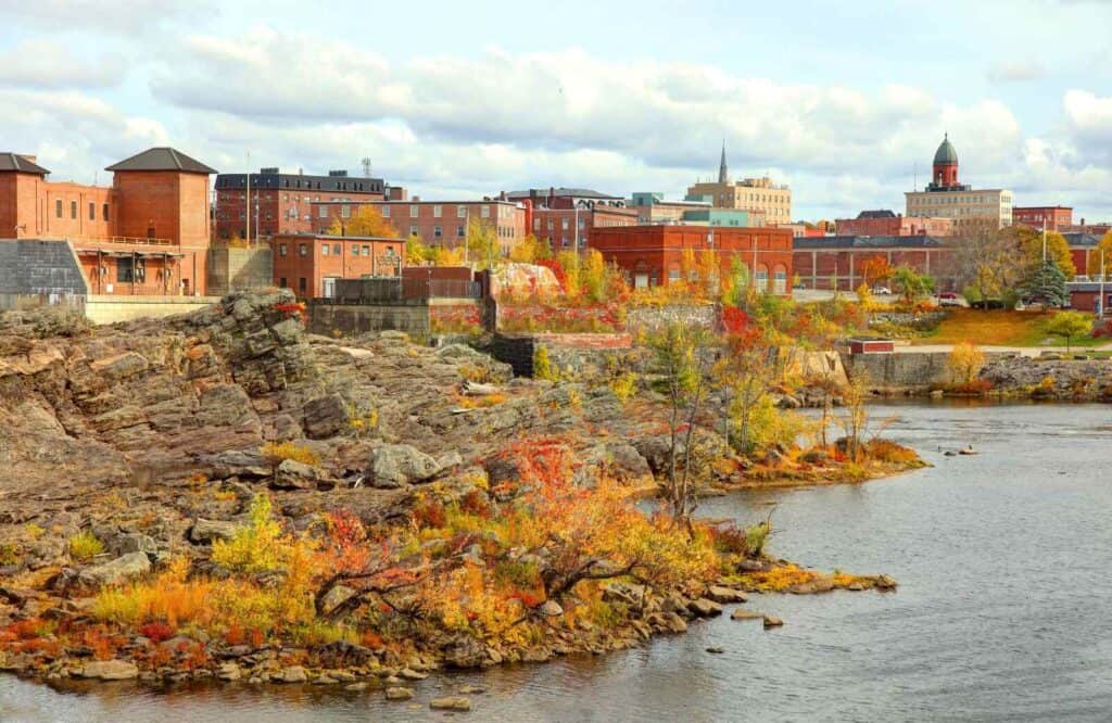 Fall foliage around the cityscape of Lewiston along the river.