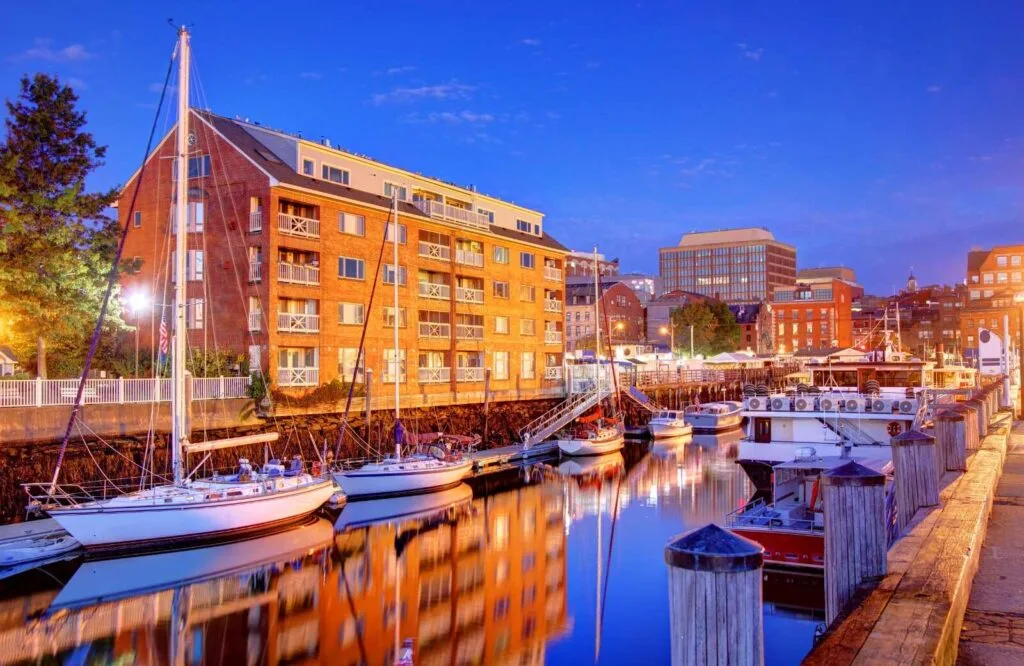 Evening view of boats in the harbor in Portland which makes it one of the best places to vacation in Maine.