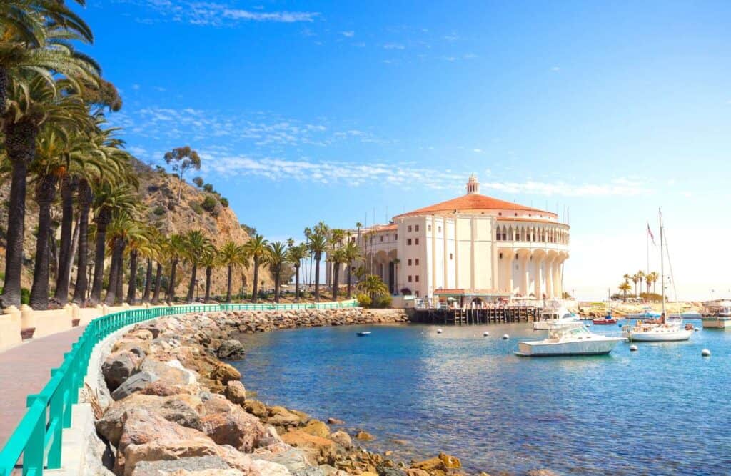 Santa Catalina Island with a walking promenade along the shore and a few boats in the water.