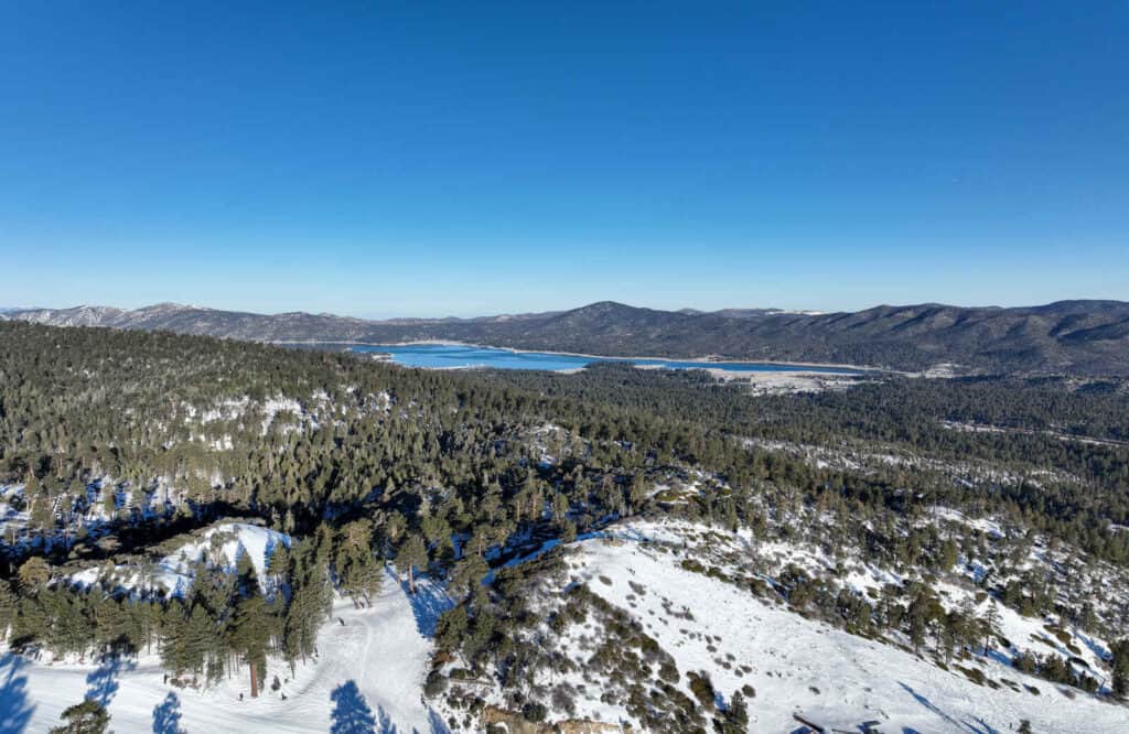 Aerial view of snow covered mountains surrounded Big Bear Lake.