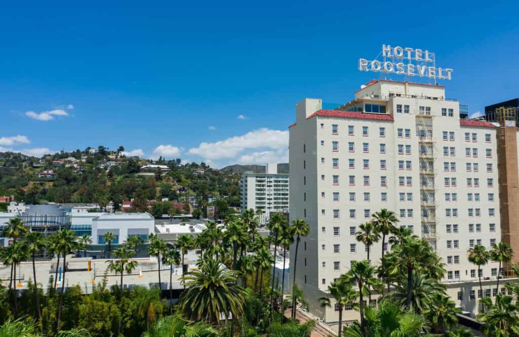 The Hollywood Roosevelt Hotel in Los Angeles with its white exterior under blue skies.