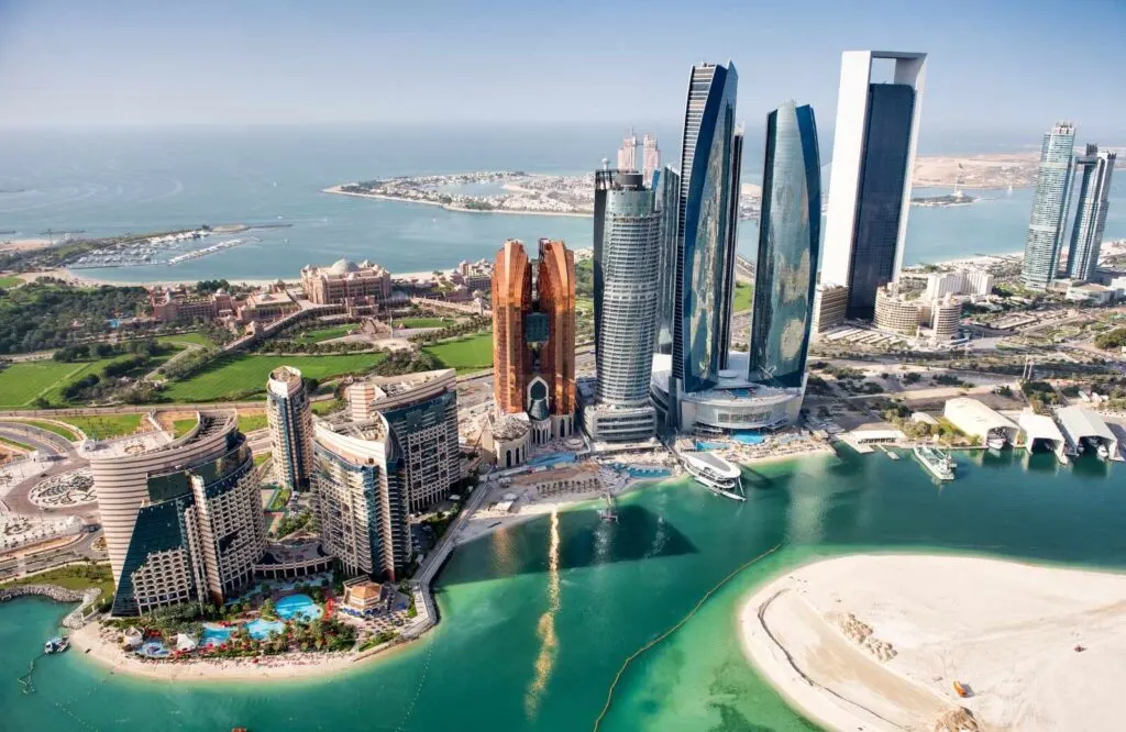 Aerial view of Abu Dhabi with skyscrapers darting out of the sea.