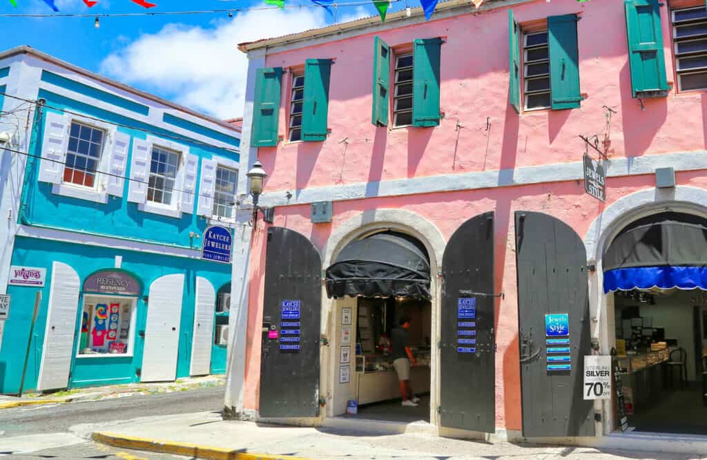 Pink and blue buildings with shops in the historic district of Charlotte Amalie.