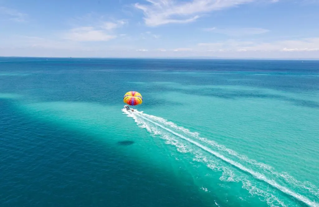 An aerial shot of a parasail over the waters of St. Thomas.