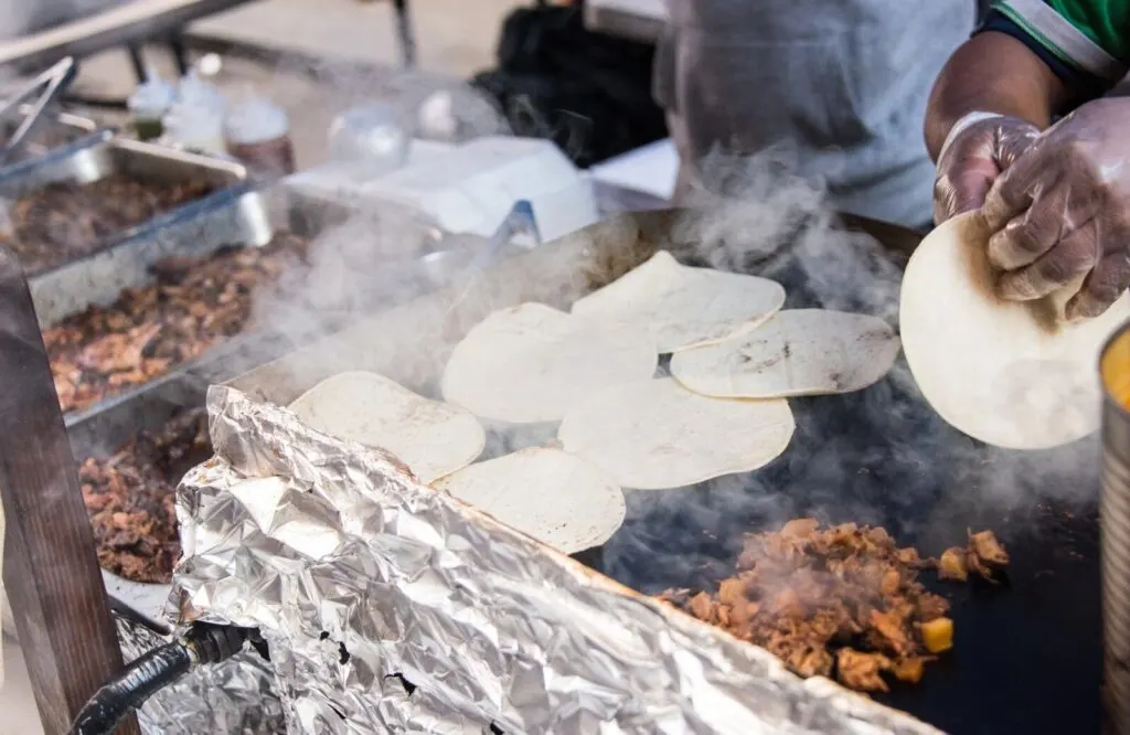 A street vendor making authentic street tacos.