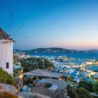 The iconic Mykonos windmills overlooking the town of Mykonos on the ocean for Mykonos in one day.
